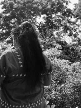 Woman seen from behind looking at the coffee farm, black and white